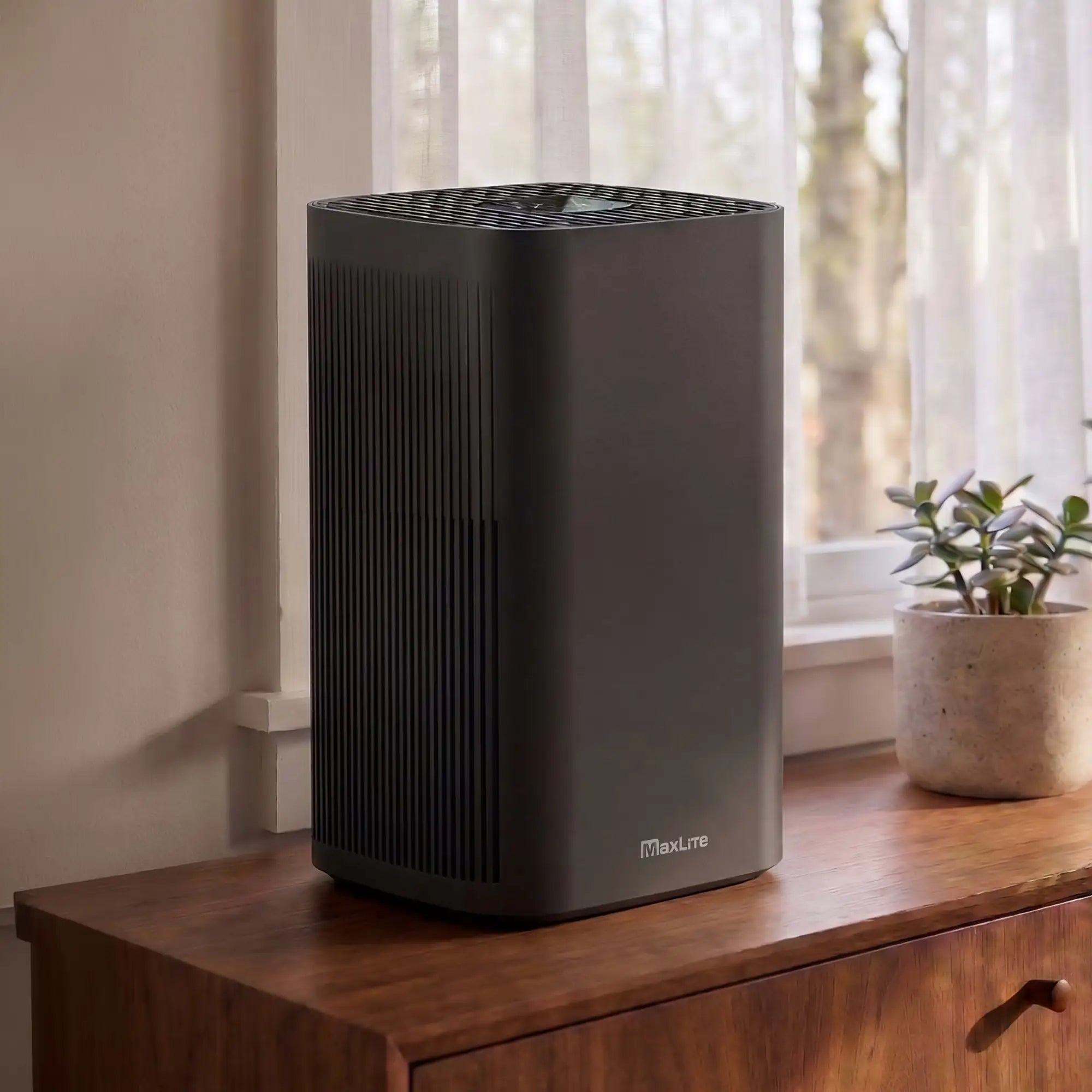 3-quarter lifestyle view of the CPM-MaxLite_AP215SF3B-air purifier on a credenza